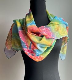 Beyond the Rainbow Dragonfly Silk Chiffon Scarf:  Show your colorful side wearing this this fluttery silk chiffon scarf. Featuring dragonflies in bright pink and orange float across a bright blue sky, grounded by streamers of lime and amber, clusters of tiny white blooms add a bit sparkle. This scarf includes all the colors of the rainbow to remind us of the infinite possibilities that come with living in our magical world.   Wear it all year around your neck, as a head scarf, over a bathing suit, looks great with white shirt or jacket. Chiffon: Chiffon silk is light and transparent, with a subtle crepe texture, don't be fooled by its delicate appearance it is a strong, breathable fabric finished with a hand rolled hem. Suitable for year round. All scarfs are painted by hand in my home stu Hand Painted Multicolor Scarves For Spring, Hand Painted Multicolor Scarves, Artsy Multicolor Silk Scarf For Summer, Hand Painted Silk Scarf For Summer, Silk Chiffon Scarves, Silk Set, Elegant Drapes, Chiffon Scarf, Rolled Hem