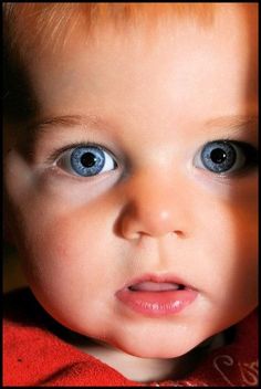 a close up of a child with blue eyes