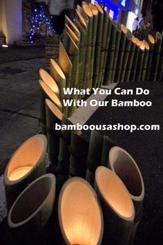 bamboo poles are lined up in front of a building with lights on the top and bottom