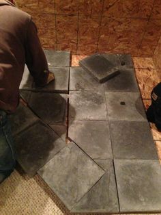 a man is working on some kind of tile