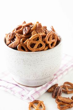 a white bowl filled with pretzels on top of a table