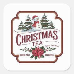 christmas tea sticker with a snowman in the middle and holly trees on it