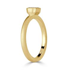 a yellow gold ring with a single stone