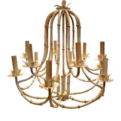 a chandelier made out of bamboo sticks with candles in the middle and leaves on each end