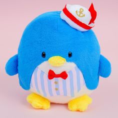 a blue penguin with a sailor's hat and bow tie sitting on a pink background