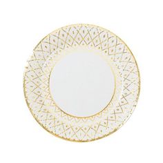 a white and gold plate with an intricate design on the rim, against a white background