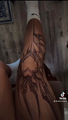 a woman's legs with tattoos on them and the bottom part of her leg