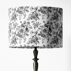 a black and white floral lamp shade on a table