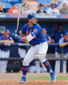 a baseball player holding a bat on top of a field in front of a crowd