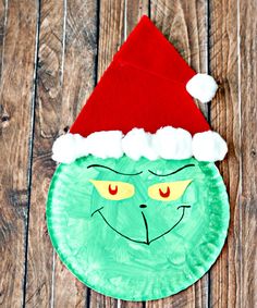 paper plate grin face with santa's hat on it