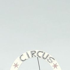 a sign that says circus with stars on it