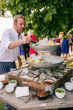 a man standing in front of a table filled with food