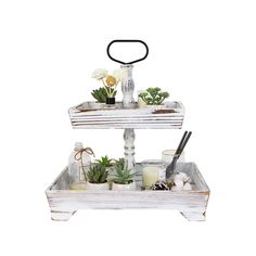 two tiered trays holding plants and candles