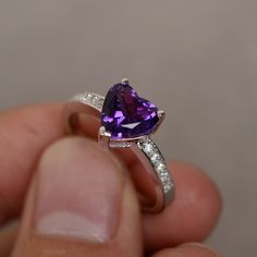 This is a gorgeous handmade creation. Its beauty is its simplicity & Elegance. The 8 mm heart cut faceted natural amethyst is crafted in solid sterling silver and with rhodium plated. All item is sent in a beautiful gift box You can realize more lovely stuff clicking the link https://www.etsy.com/shop/knightjewelry?refshopsection_shophome_leftnav Please leave the correct address and you phone number for delivering successfully. Fine Jewelry Amethyst Heart Cut Birthstone Ring, Heart Cut Amethyst Birthstone Ring Fine Jewelry, Heart Cut Amethyst Jewelry With Center Stone, Heart Cut Amethyst Ring With Accent Stones, Heart Cut Amethyst Birthstone Jewelry, Fine Jewelry Amethyst Ring Heart Cut, Amethyst Heart Cut Ring For Anniversary, Fine Jewelry Heart Cut Amethyst Ring, Purple Amethyst Heart Cut Ring For Valentine's Day