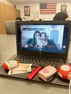 an open laptop computer sitting on top of a table