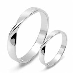 two white gold wedding rings on top of each other, one is plain and the other is plain