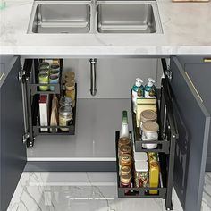 two sinks in the middle of a kitchen with pull out shelves for spices and condiments