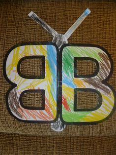 a child's drawing of the letter b on a piece of burlock