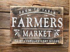 a wooden sign that says farmers market on it