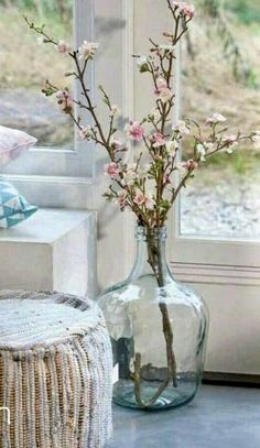 a vase filled with flowers next to a window