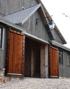 an open barn door on the side of a house