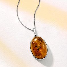 Ross-Simons - Oval Cognac Amber Pendant Necklace in Sterling Silver. 20". Connected to nature, this organic gemstone is absolutely stunning. Filled with vintage-style inspiration, a beautiful 30x20mm oval cognac amber cabochon dangles from a curb chain with a springring clasp. Set in polished sterling silver. Amber pendant necklace. Oval Amber Gemstone Jewelry, Oval Amber Necklace For Anniversary, Classic Oval Cabochon Necklace With Polished Finish, Elegant Amber Oval Cabochon Necklace, Elegant Oval Amber Necklaces, Classic Oval Cabochon Necklace, Oval Jewelry With Natural Inclusions For Formal Occasions, Formal Oval Jewelry With Natural Inclusions, Formal Oval Amber Necklace