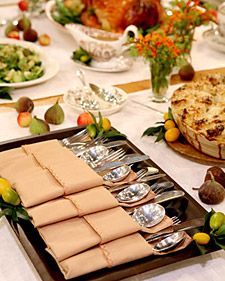 a table filled with lots of food and silverware