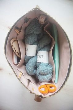 yarn, scissors and knitting needles in a bag