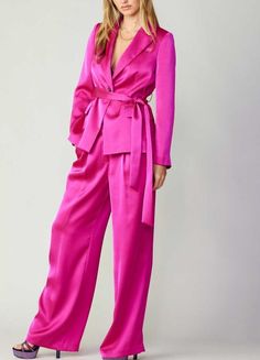 Buttoned silky front pintucked trousers. Available in black and fuchsia. Pair with our silky belted one button jacket (Style # 2320101) for the complete look! 100% Polyester Formal Pink Satin Bottoms, Pink Silk Evening Pants, Elegant Pink Pantsuit For Fall, Pink Pantsuit For Fall Party, Silky Pants, Belted Blazer, Jumpsuit Jacket, Pleated Trousers, Belted Jacket