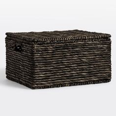 an empty wicker basket with handles on the bottom is shown in front of a white background