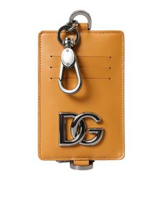 Dolce & Gabbana men’s card holder wallet. Its elegant orange hue and premium calf leather craftsmanship make it a statement accessory that’s both functional and stylish. With a convenient zipper closure and subtle logo details, this Italian-made card holder brings sophistication and practicality to your everyday carry.   Material: 100% Calf Leather  Color: Orange  Country of origin: Italy  Measurements: 13cm x 9cm x 1cm Luxury Leather Wallet With Silver-tone Logo, Leather Card Holder With Logo Plaque For Everyday, Luxury Brown Wallet With Logo Plaque, Designer Leather Card Holder With Logo, Dolce Gabbana Men, Orange Country, Leather Credit Card Holder, Credit Card Holder Wallet, Orange Material