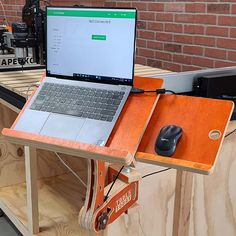 an open laptop computer sitting on top of a wooden table