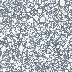 a blue and white background with lots of small rocks on it's surface,