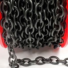 a black chain is attached to a red object