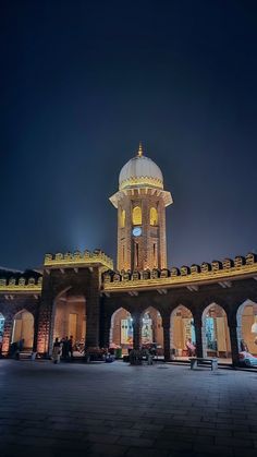 a clock tower is lit up at night