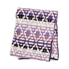 two purple and white crocheted dishcloths sitting on top of each other