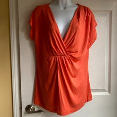 Tangerine Colored Cap Sleeve V-Neck Slouchy Top For Spring, Orange V-neck Top For Day Out, Casual Slouchy V-neck Tops, Casual Orange V-neck Crop Top, Feminine Orange V-neck Top, Orange Stretch V-neck Top, Stretch Orange V-neck Top, Orange Relaxed Fit Short Sleeve T-shirt, Tangerine Color