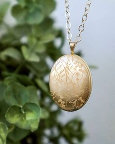 This gold filled locket is a beautiful, classic piece of jewelry now engraved with a delicate floral pattern. Select the light finish for a subtle engraving, reflecting in gold  or the darker fill to see the a bolder contrast accentuating the flowing lines along the locket surface. This will be a lasting heirloom that can be worn and treasured throughout the wonderful moments of your life.  ITEM DETAILS  * See listing photo for available Gold Filled locket sizes * Available in the classic polished or brushed matte style * Gold Filled chain * Engraving samples shown on: Top left to right: shiny light engraving, shiny dark engraving bottom left to right: matte light engraving, matte dark engraving  Additional engraving and photos can be purchased with this listing: http://etsy.me/1yX7s3S  HO Elegant 14k Gold Locket Necklace Gift, Gold Locket Necklace With Intricate Round Pendant, Gold Locket Necklace With Intricate Design, Gold Locket Necklace With Intricate Design And Round Pendant, Elegant Round Pendant Locket Necklace With Birth Flower, Elegant Round Locket Necklace With Birth Flower, Elegant Yellow Gold Locket Necklace For Keepsake, Elegant Birth Flower Round Pendant Locket Necklace, Wedding Pendant Jewelry With Engraving Option