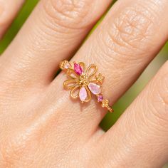 There's power in the flowers! Pink crystals peeking through a floral design, adding a touch of magic to your everyday style. It's feminine and simple and the perfect statement ring. Flower Shaped Birthstone Ring, Flower Shaped Birthstone Promise Ring, Spring Rose Gold Flower Ring, Pink Flower Promise Ring, Delicate Flower Ring For Spring, Adjustable Crystal Flower Ring, Adjustable Flower Crystal Ring, Spring Flower Promise Ring, Dainty Pink Flower Ring