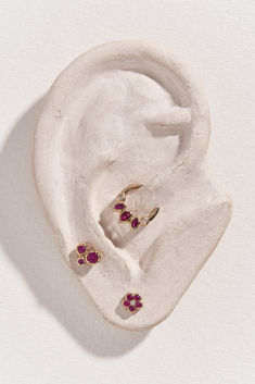 a pair of earring sitting on top of a white surface