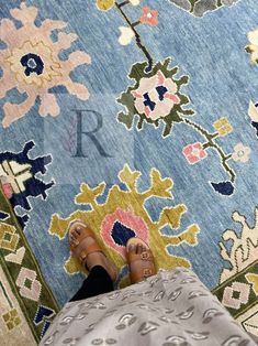 a person standing on top of a colorful rug