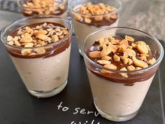 three desserts in small glass cups with nuts on top