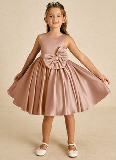 Apple showcases a lovely A-line silhouette in smooth matte satin. With a classic scoop neckline and sleeveless design, it features a stylish bow tie back and playful bows, making it an adorable choice for any whimsical celebration. Satin Flower Girl Dresses, Champagne Rose, Sage Dress, Military Ball Dresses, Special Event Dresses, Lace Bride, Rhinestone Dress, Ivory Dresses, Black Wedding Dresses