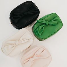 Introducing our Madelyn Bow Makeup Bag - the perfect travel companion for all your beauty needs! Available in 4 stylish colors, this bag not only looks chic but also offers ample space for all your makeup, hair supplies, and essentials. Plus, the top zipper pocket comes with a convenient compact mirror. Stay organized, elegant, and always ready with our trendy and easy-to-clean makeup bag. The Madelyn Bow Makeup Bag is another addition to our 3 Sisters Collection! This collection is inspired by Pink Leather Makeup Bag, Playful Pink Cosmetic Bag For Everyday Use, Compact Pink Cosmetic Bag, Cheap Pink Playful Cosmetic Bag, Versatile Pink Cosmetic Bag For On-the-go, Inside Bag, Hair Supplies, Summer Clearance, Hair Essentials