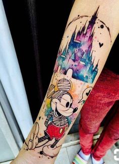 a person with a mickey mouse tattoo on their arm