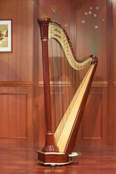 a large wooden harp sitting on top of a hard wood floor