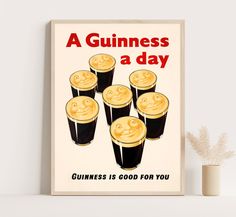 a guinness poster on a shelf next to a vase