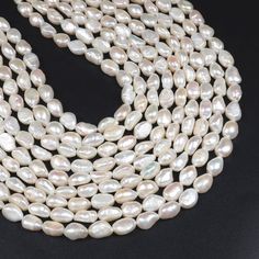 a strand of white pearls on a black background