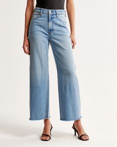 Our classic high rise cropped wide leg jeans in a medium wash with a raw-cut hem. This fit features a 10.5” high rise, is relaxed at the waist and hips, and eases into a wide, full-length leg shape with a cropped length. This jean is made from our super light drapey denim fabric, which features a super soft lightweight rigid denim. Medium Wash Cropped Jeans With Frayed Hem, Medium Wash Cropped Flare Jeans With Frayed Hem, Light Wash Cropped Flare Jeans With Relaxed Fit, Straight Cropped Jeans With Frayed Hem, Cropped Denim Flare Jeans With Frayed Hem, Cropped Flare Jeans With Frayed Hem, Cropped Medium Wash Bottoms With Frayed Hem, Cropped Medium Wash Flare Jeans, Cropped Denim Blue Flare Jeans With Frayed Hem