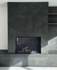 the fireplace is made out of concrete and has a fire place